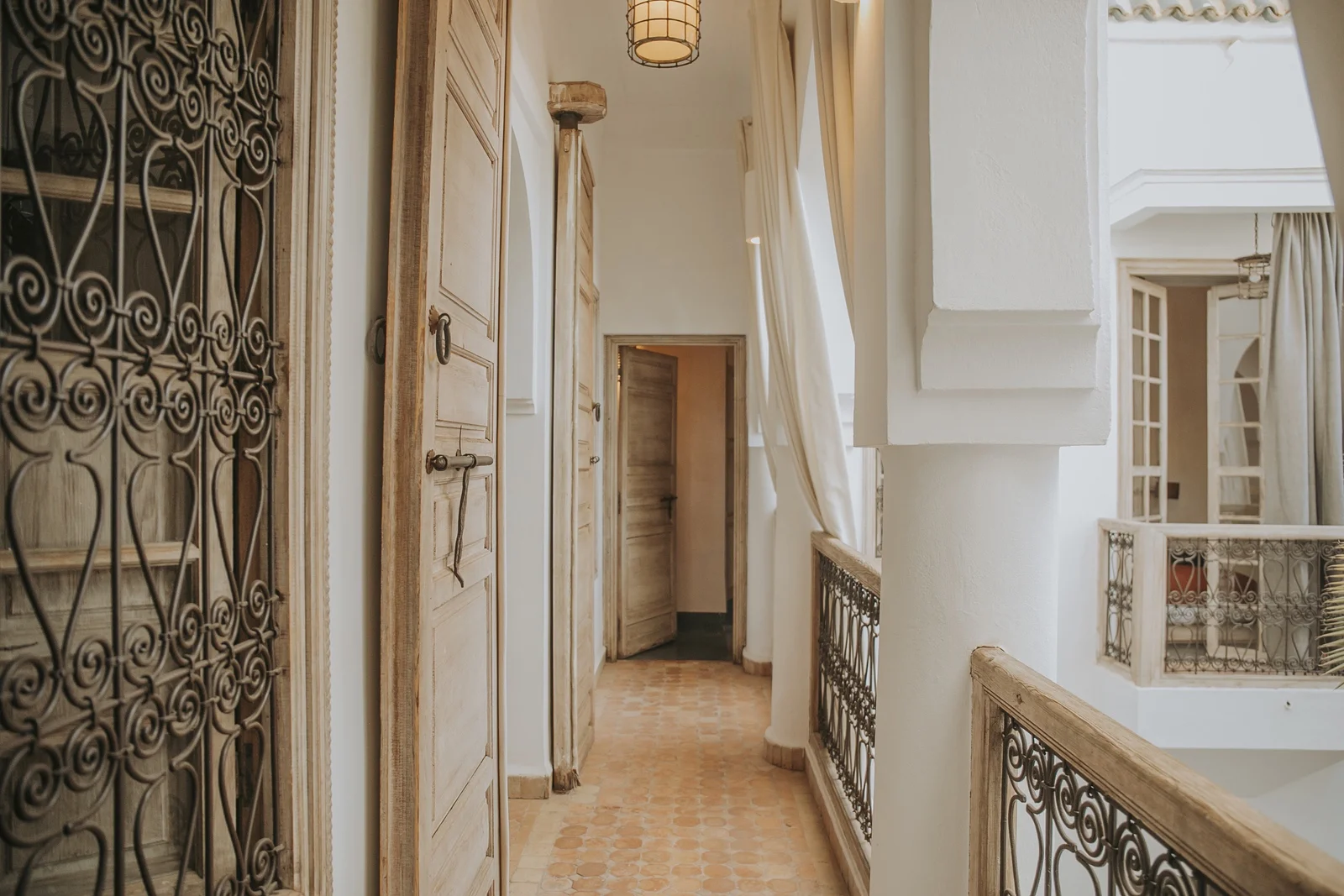 The upstairs gallery of Dar Zelda — carved cedar doors and wrought-iron balustrades