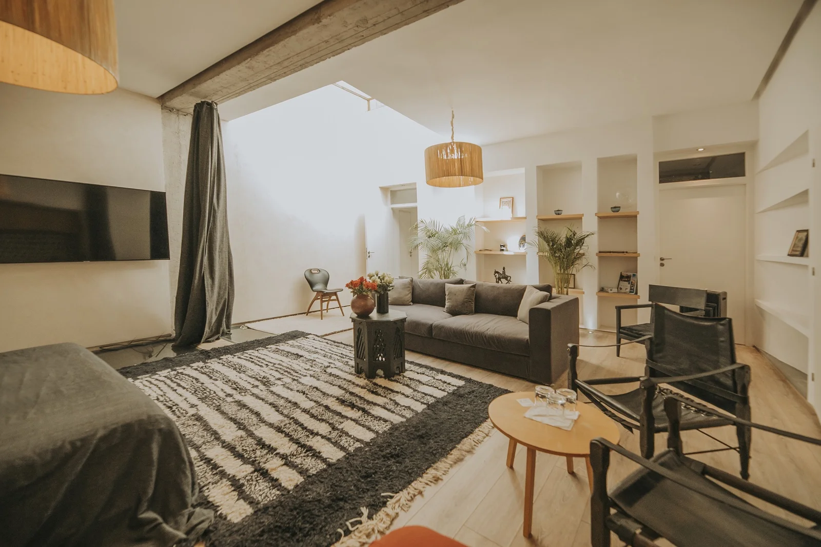 The Loft Suite at Dar Zelda, with its bare stone wall and exposed beams — view 3