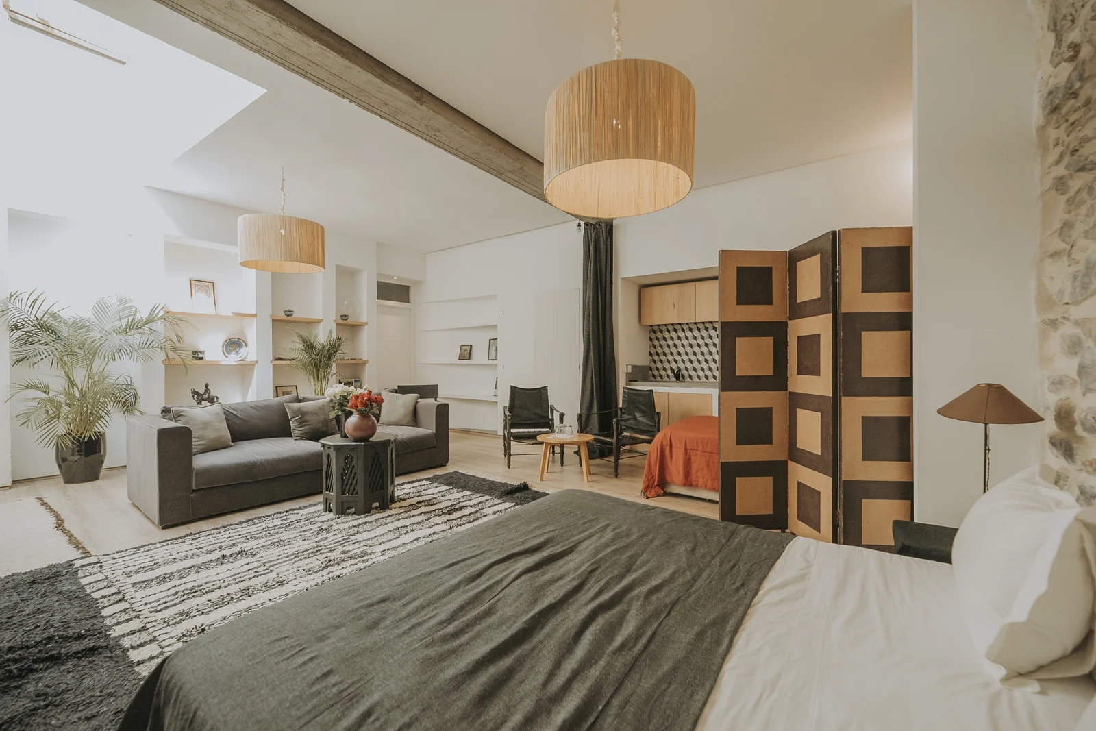 The Loft Suite at Dar Zelda, with its bare stone wall and exposed beams — view 2
