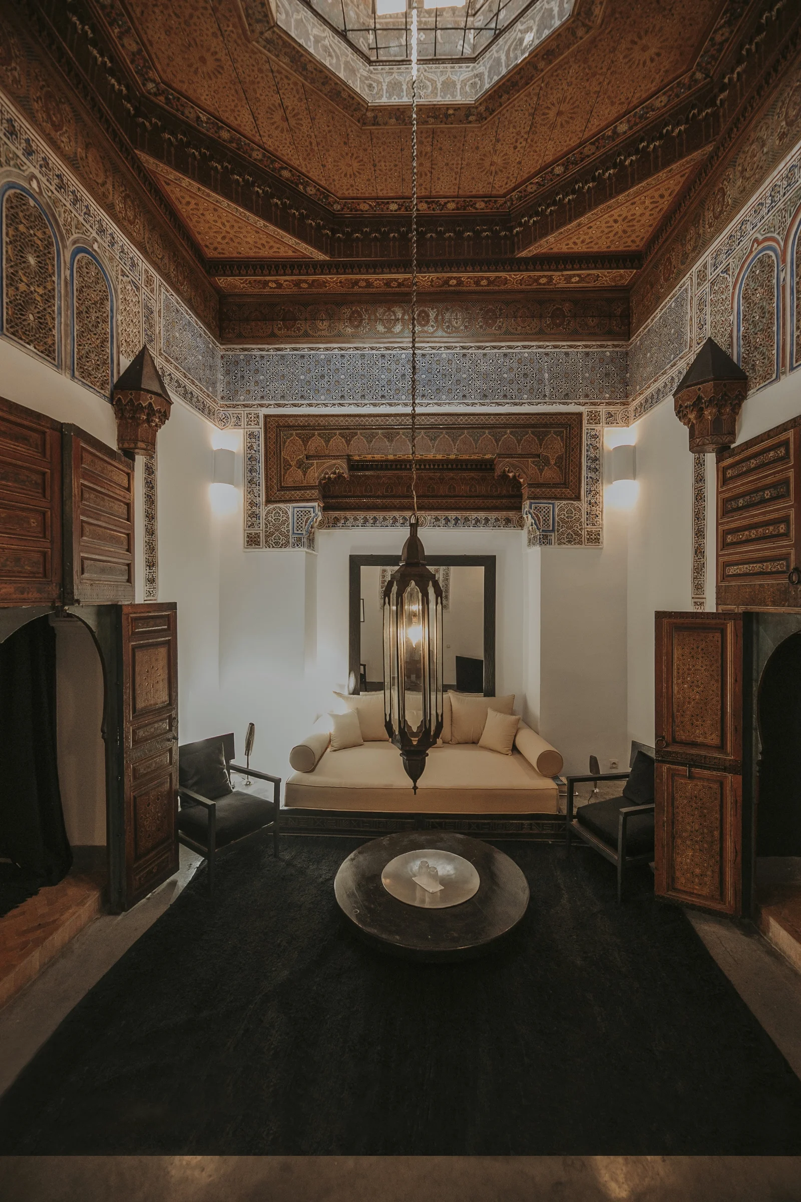 The 18th-century ceremonial salon of Dar Zelda — cupolas, hand-painted frescoes and the painted-cedar ceiling above the day bed