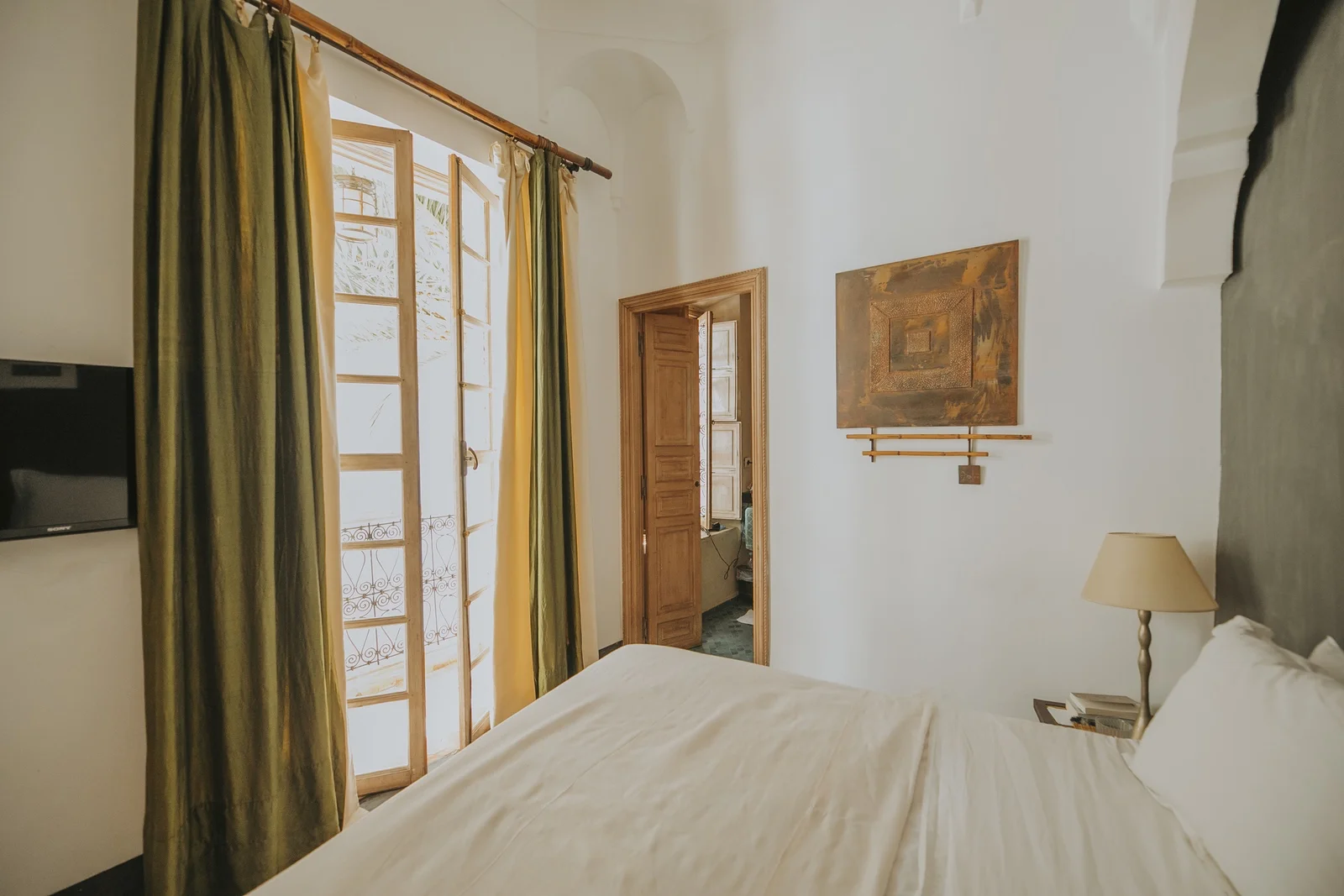 The Vegetale Standard Room at Dar Zelda and its balcony over the flowering courtyard — view 2